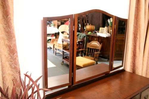 An exquisite three-drawer Imbuia dressing table with side-folding mirrors and a stool