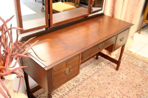 An exquisite three-drawer Imbuia dressing table with side-folding mirrors and a stool
