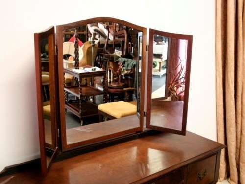 An exquisite three-drawer Imbuia dressing table with side-folding mirrors and a stool