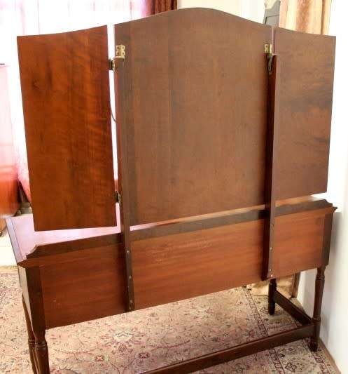 An exquisite three-drawer Imbuia dressing table with side-folding mirrors and a stool