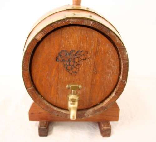 A fabulous small vintage solid Oak wine barrel with its original brass hoops, tap and stand!