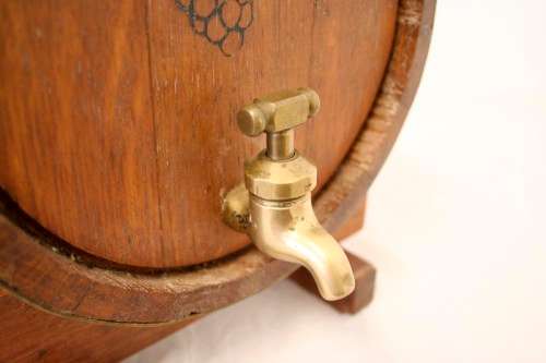 A fabulous small vintage solid Oak wine barrel with its original brass hoops, tap and stand!