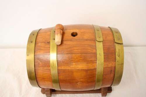 A fabulous small vintage solid Oak wine barrel with its original brass hoops, tap and stand!