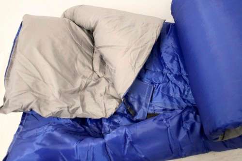 An awesome "Camp master 200E" hollow fibre, temperature rating sleeping bag in its carry bag.