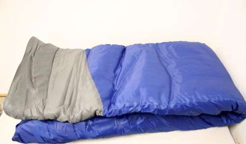 An awesome "Camp master 200E" hollow fibre, temperature rating sleeping bag in its carry bag.