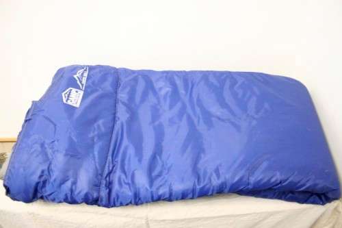 An awesome "Camp master 200E" hollow fibre, temperature rating sleeping bag in its carry bag.