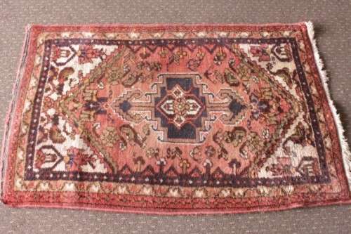 An awesome vintage/ antique? hand dyed Persian carpet (127cm x 80cm) with red and earthy tones