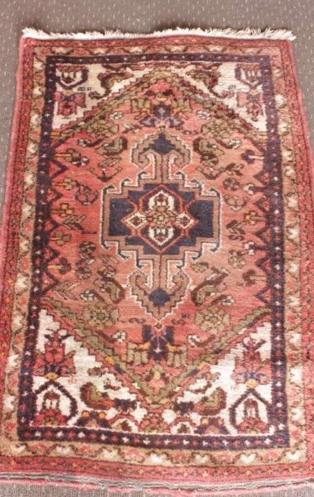 An awesome vintage/ antique? hand dyed Persian carpet (127cm x 80cm) with red and earthy tones