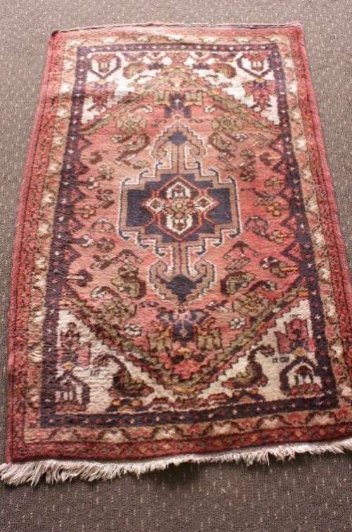 An awesome vintage/ antique? hand dyed Persian carpet (127cm x 80cm) with red and earthy tones