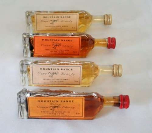 4 miniature Mountain Range sealed bottles of Cape brandy and Cream sherry, for display purposes only