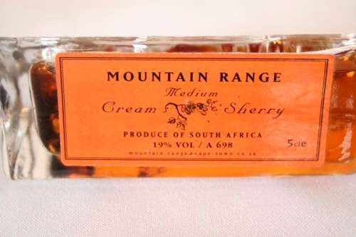 4 miniature Mountain Range sealed bottles of Cape brandy and Cream sherry, for display purposes only