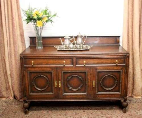An exquisite vintage Oak side server cabinet with brass handles & loads of drawer & cupboard space