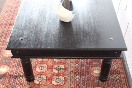 A stunning Indonesian Teak coffee table with clean lines, thick turned legs and carved detailing