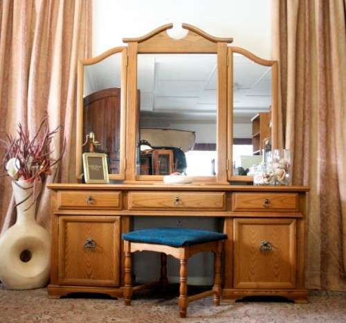 An exquisite, large Oak three drawer side-folding mirror dressing table with two cupboards and stool