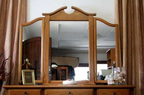 An exquisite, large Oak three drawer side-folding mirror dressing table with two cupboards and stool