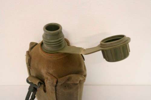 **RS17** A vintage olive green SADF military water bottle with webbing cover in good condition