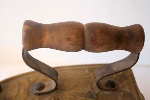 A fabulous very ornate antique brass sad iron/coal iron. Stunning as a display piece.