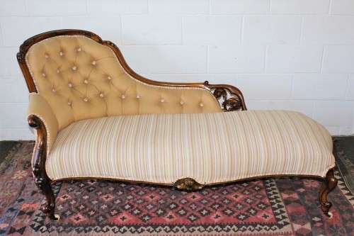 An incredible antique Victorian solid hand carved Mahogany upholstered Chaise Lounge on castors