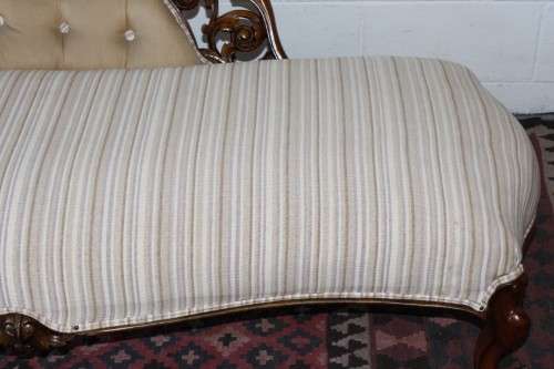 An incredible antique Victorian solid hand carved Mahogany upholstered Chaise Lounge on castors
