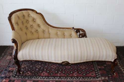 An incredible antique Victorian solid hand carved Mahogany upholstered Chaise Lounge on castors