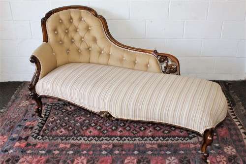An incredible antique Victorian solid hand carved Mahogany upholstered Chaise Lounge on castors