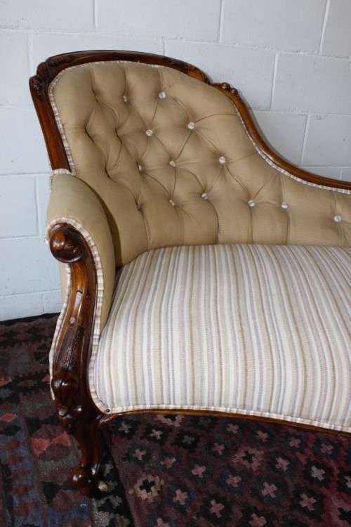 An incredible antique Victorian solid hand carved Mahogany upholstered Chaise Lounge on castors