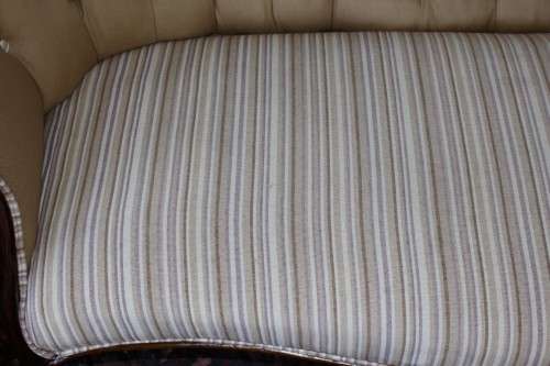 An incredible antique Victorian solid hand carved Mahogany upholstered Chaise Lounge on castors