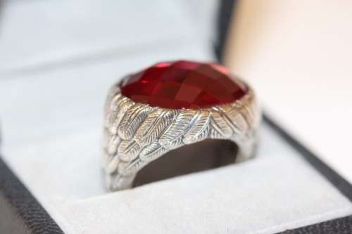 A stunning sterling silver ring with a huge faceted garnet centre stone and exquisite detailing