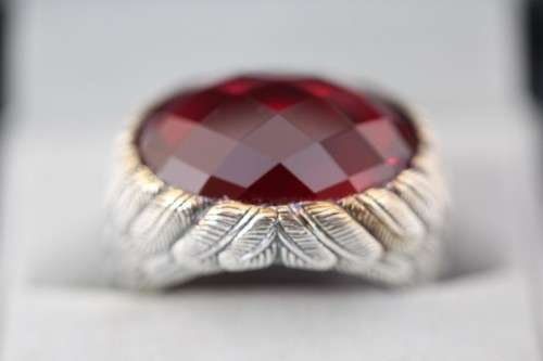 A stunning sterling silver ring with a huge faceted garnet centre stone and exquisite detailing