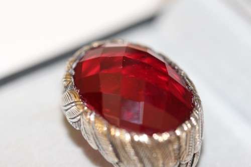 A stunning sterling silver ring with a huge faceted garnet centre stone and exquisite detailing