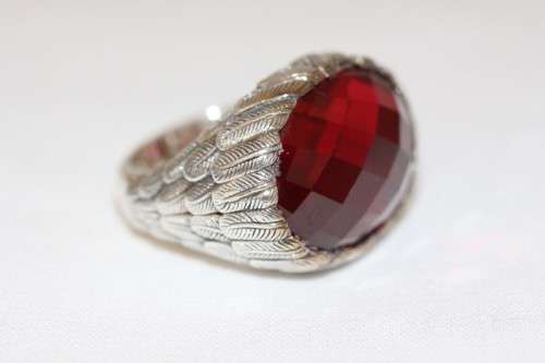 A stunning sterling silver ring with a huge faceted garnet centre stone and exquisite detailing