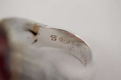 A stunning sterling silver ring with a huge faceted garnet centre stone and exquisite detailing