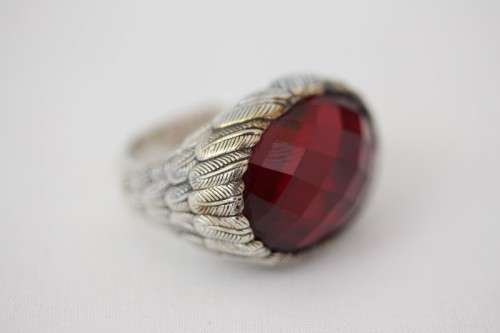 A stunning sterling silver ring with a huge faceted garnet centre stone and exquisite detailing
