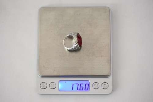 A stunning sterling silver ring with a huge faceted garnet centre stone and exquisite detailing