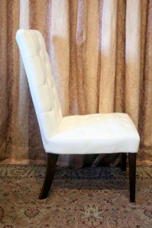 Six stunning white faux leather high-back diningroom chairs, stylish and comfortable. Price/chair