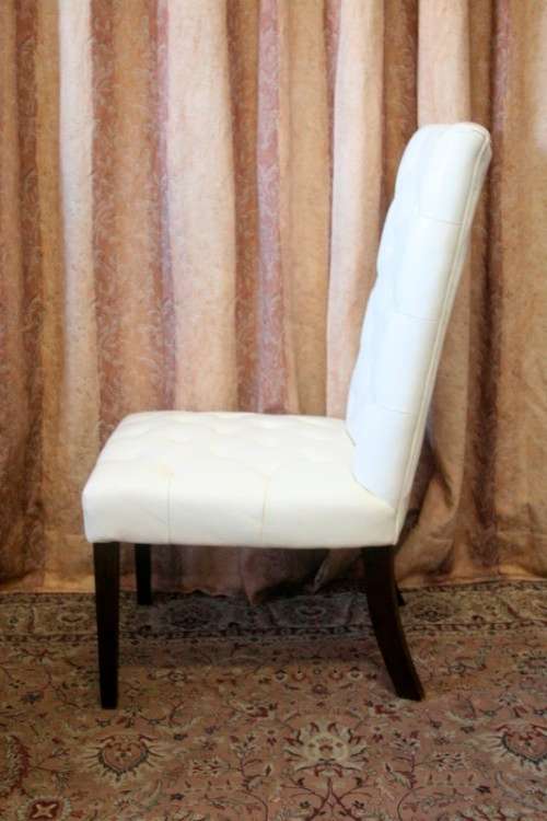 Six stunning white faux leather high-back diningroom chairs, stylish and comfortable. Price/chair