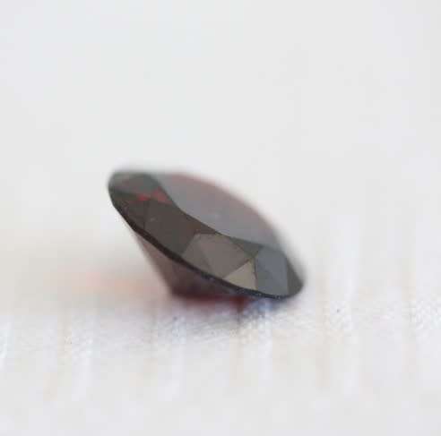 A stunning and vibrant round faceted cut 7-carat garnet semi-precious stone