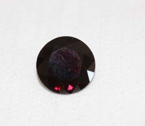 A stunning and vibrant round faceted cut 7-carat garnet semi-precious stone