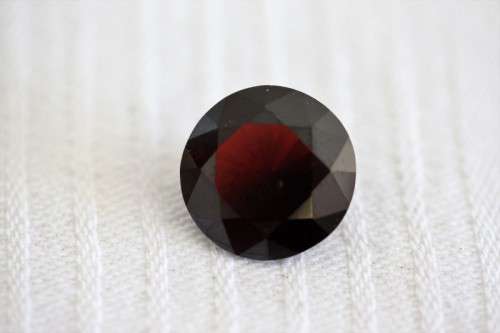 A stunning and vibrant round faceted cut 7-carat garnet semi-precious stone