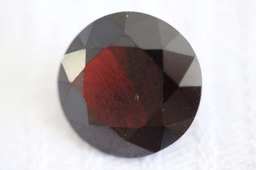 A stunning and vibrant round faceted cut 7-carat garnet semi-precious stone