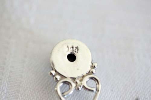A beautiful sterling silver (925) earring set with round raised onyx stones and ornate detailing