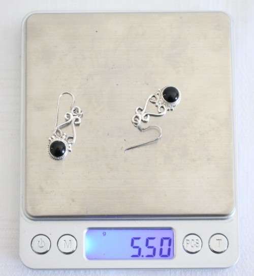 A beautiful sterling silver (925) earring set with round raised onyx stones and ornate detailing