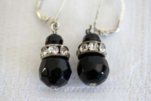 A gorgeous matching black stone and silver metal pendant and earring set with diamante