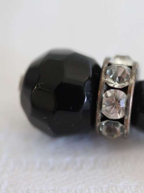 A gorgeous matching black stone and silver metal pendant and earring set with diamante