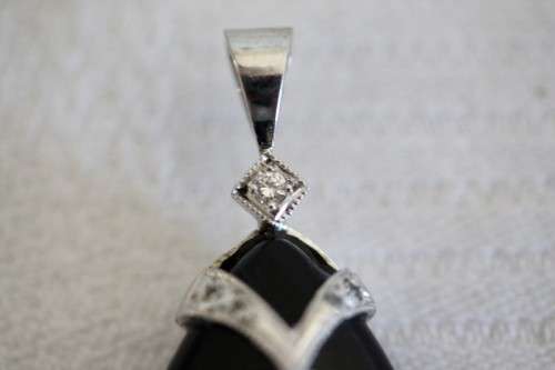 A gorgeous matching black stone and silver metal pendant and earring set with diamante