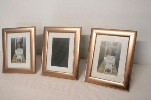 **RS17** Three lovely medium sized bronze coloured free standing photo frames with glass.