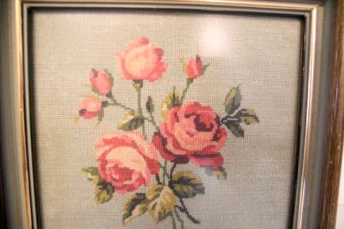 A lovely framed (behind glass) hand made tapestry of roses in great condition.