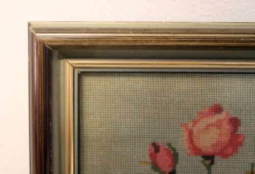 A lovely framed (behind glass) hand made tapestry of roses in great condition.