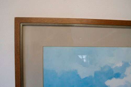 **RS17** A beautiful signed "Wessel Marais" print framed W/ glass in a wood frame of seaside houses.