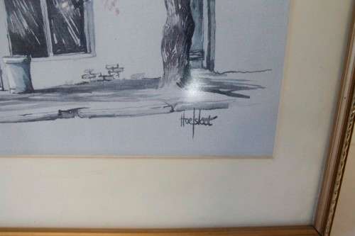 **RS17** A beautiful signed "Ted Hoefsloot" print framed behind glass of a scene of houses.